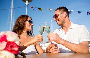 Image showing smiling couple drinking champagne at cafe