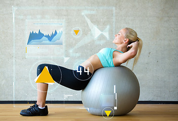 Image showing smiling woman with exercise ball in gym