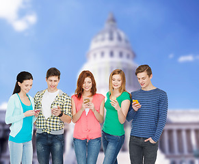 Image showing smiling students with smartphones