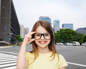 Image showing smiling cute little girl in black eyeglasses