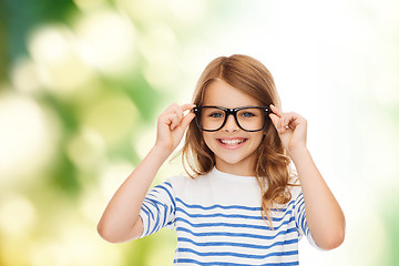 Image showing smiling cute little girl with black eyeglasses