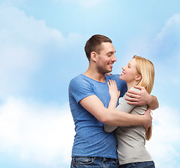 Image showing smiling couple hugging and looking at each other