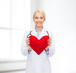 Image showing smiling female doctor with heart and stethoscope