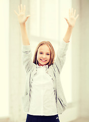 Image showing student girl with hands up at school