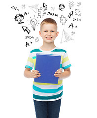 Image showing smiling little student boy with blue book