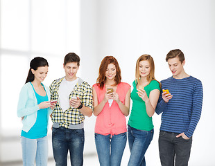 Image showing smiling students with smartphones