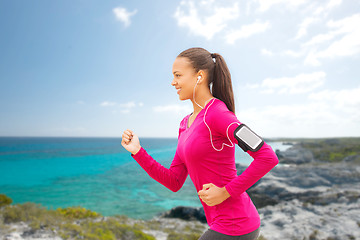 Image showing smiling young woman running outdoors