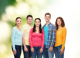 Image showing group of smiling teenagers over green background