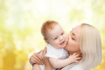 Image showing happy mother kissing smiling baby