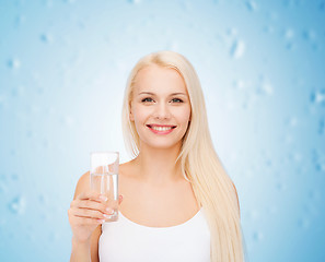 Image showing young smiling woman with glass of water