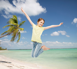 Image showing smiling little girl jumping