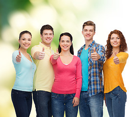 Image showing group of smiling teenagers over green background