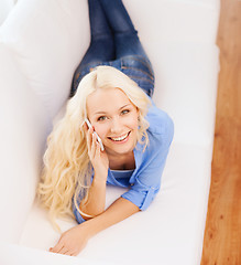 Image showing smiling woman with smartphone at home