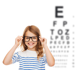 Image showing smiling cute little girl with black eyeglasses