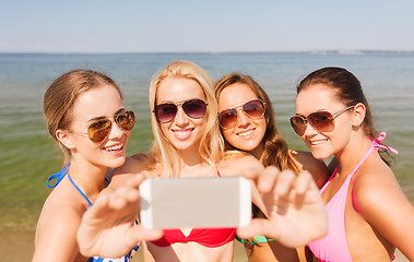 Image showing group of smiling women making selfie on beach