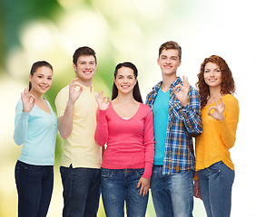 Image showing group of smiling teenagers over green background