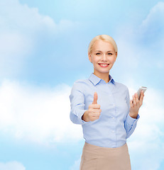 Image showing young smiling businesswoman with smartphone