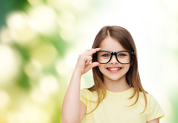 Image showing smiling cute little girl in black eyeglasses