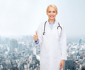 Image showing smiling female doctor showing thumbs up