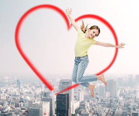 Image showing smiling little girl jumping