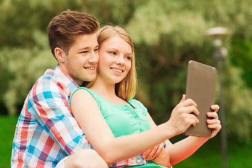 Image showing smiling couple with tablet pc making selfie