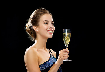 Image showing laughing woman holding glass of sparkling wine