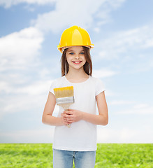 Image showing smiling little girl in helmet with paint brush