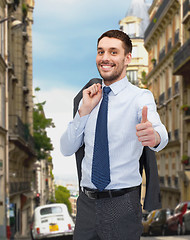 Image showing smiling young businessman showing thumbs up