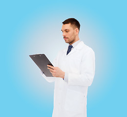 Image showing serious male doctor with clipboard