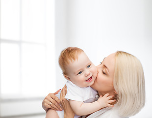 Image showing happy mother kissing smiling baby