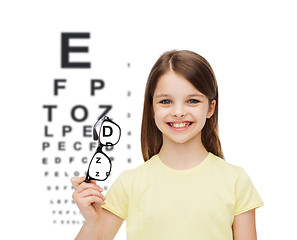 Image showing smiling cute little girl holding black eyeglasses