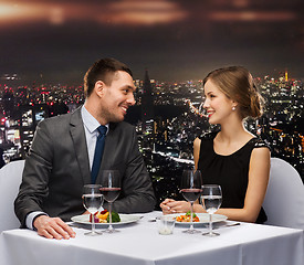 Image showing smiling couple eating main course at restaurant