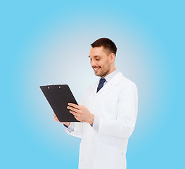 Image showing smiling male doctor with clipboard