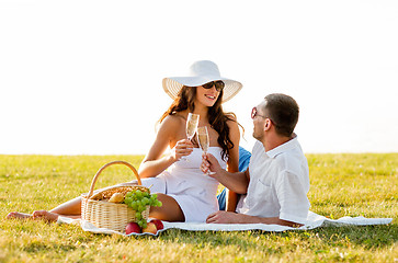 Image showing smiling couple drinking champagne on picnic