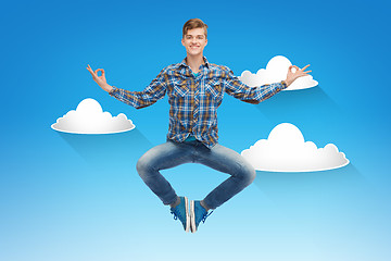 Image showing smiling young man jumping in air