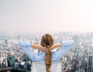 Image showing businesswoman sitting on chair from back