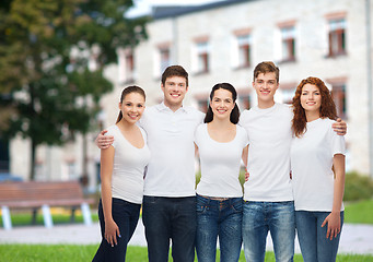 Image showing group of smiling teenagers in white blank t-shirts