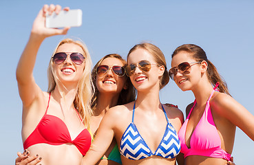 Image showing group of smiling women making selfie on beach