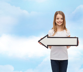Image showing smiling girl with blank arrow pointing left