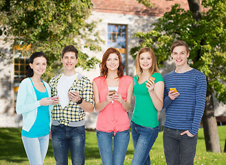 Image showing smiling students with smartphones