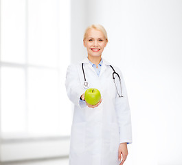 Image showing smiling female doctor with green apple