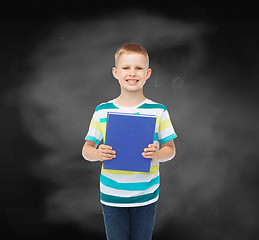 Image showing smiling little student boy with blue book