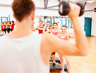 Image showing group of smiling female with dumbbells and step