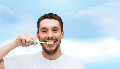 Image showing smiling young man with toothbrush