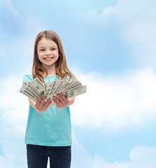 Image showing smiling little girl giving dollar cash money