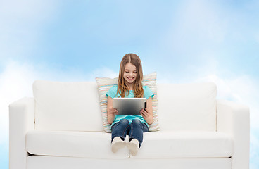 Image showing little girl sitting on sofa with tablet pc