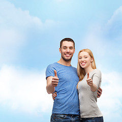 Image showing smiling couple showing thumbs up