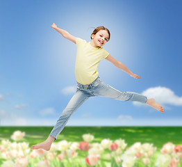 Image showing smiling little girl jumping