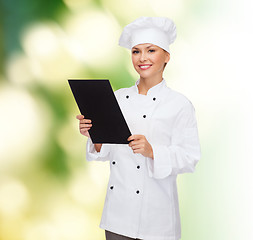 Image showing smiling female chef with black blank paper