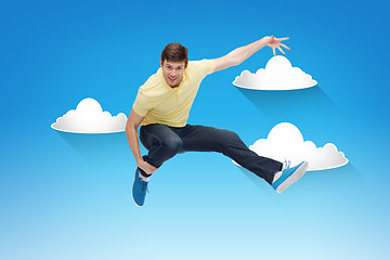 Image showing smiling young man jumping in air